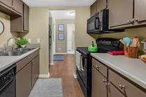Modern kitchen featuring wood-style flooring and black appliances