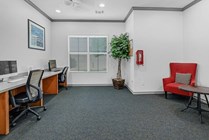 Focus in the business center with Desks, Chairs, and Plenty of Natural Light