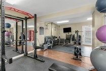 Lift weights in the Spacious Fitness Center with Equipment at Raiders Walk